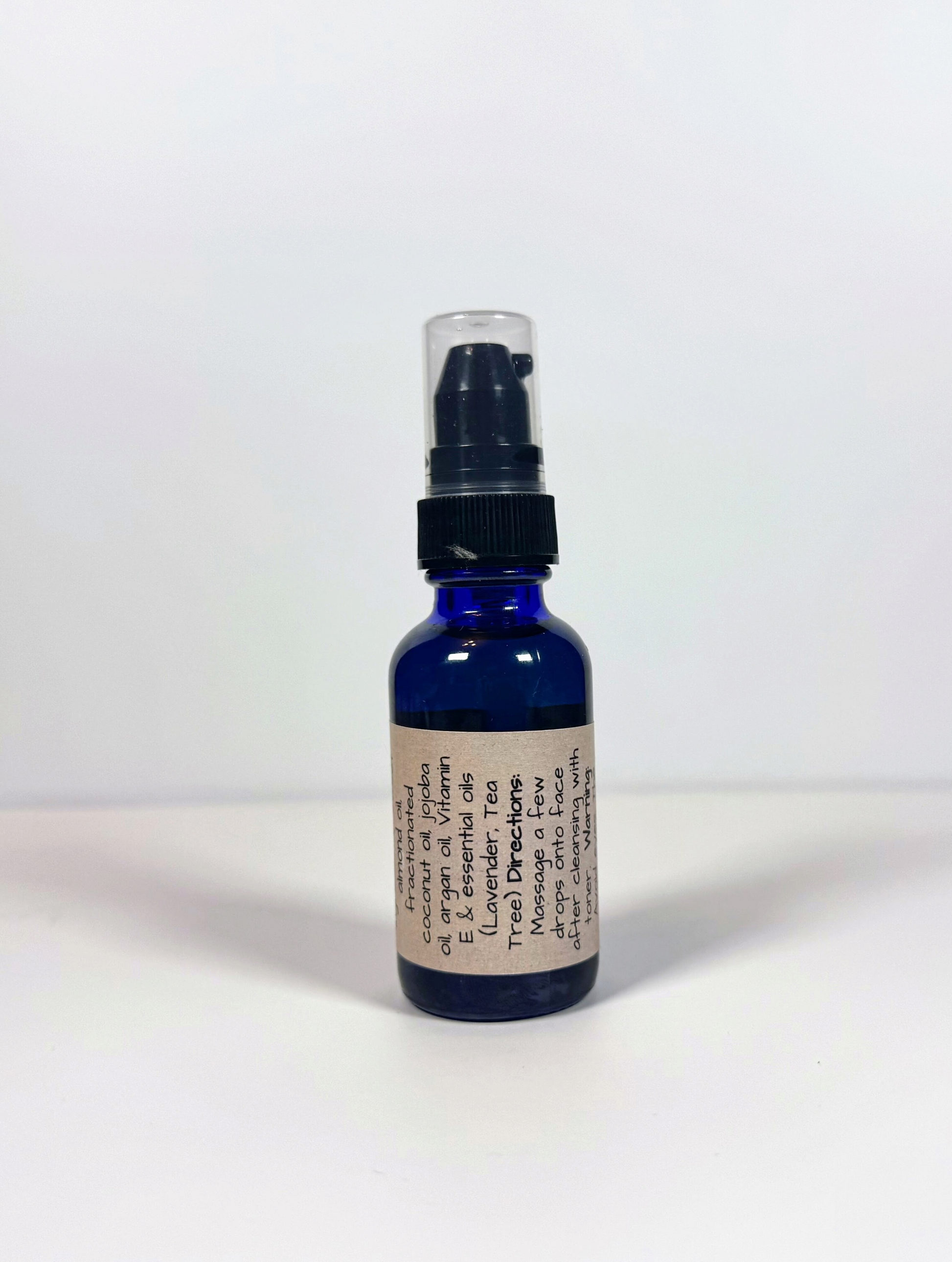 Blue spray bottle with a label on a white background