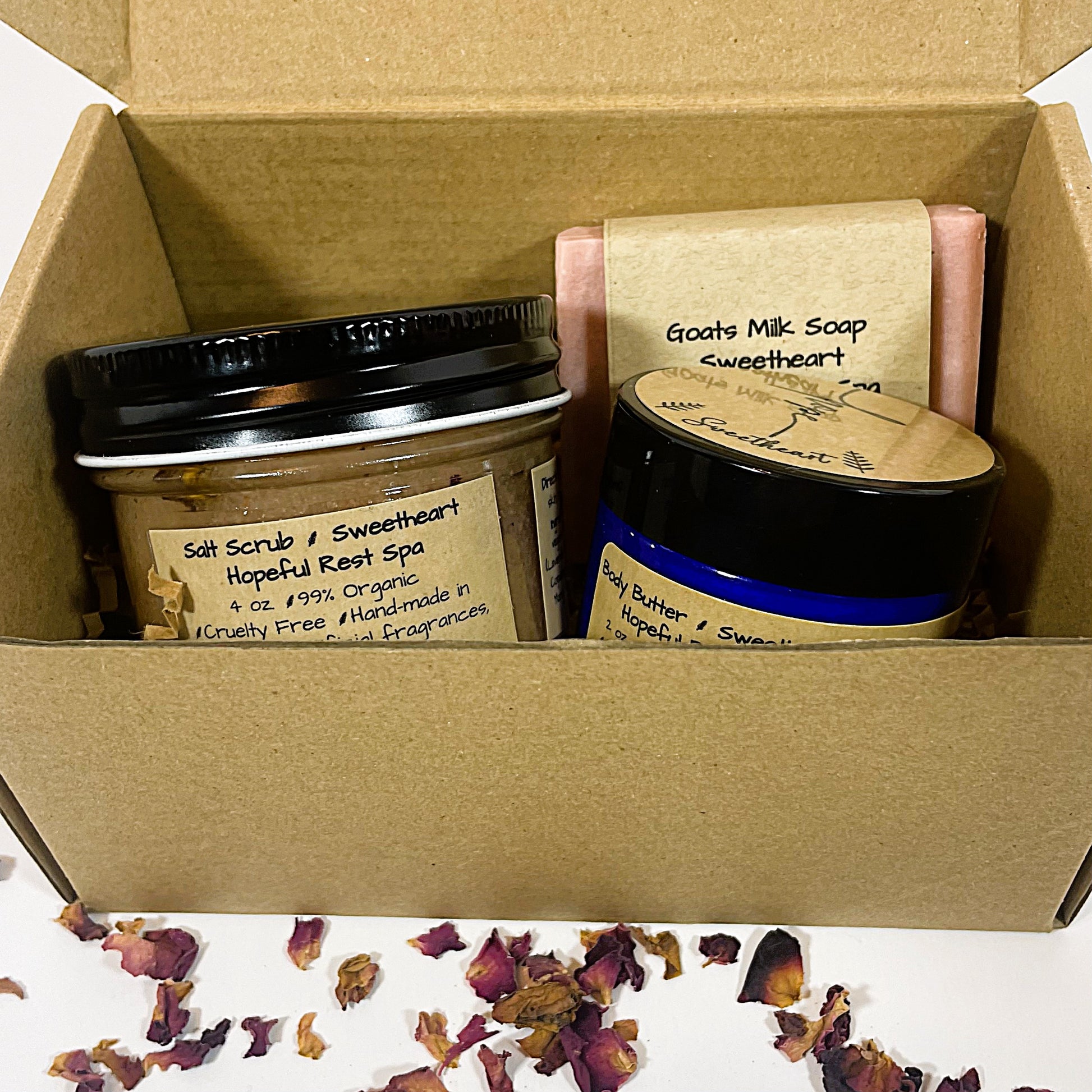 Sweetheart gift set with salt scrub, body butter, and soap in a box with petals in front