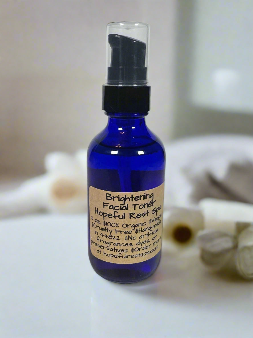 Blue bottle of facial toner with a label on a neutral background