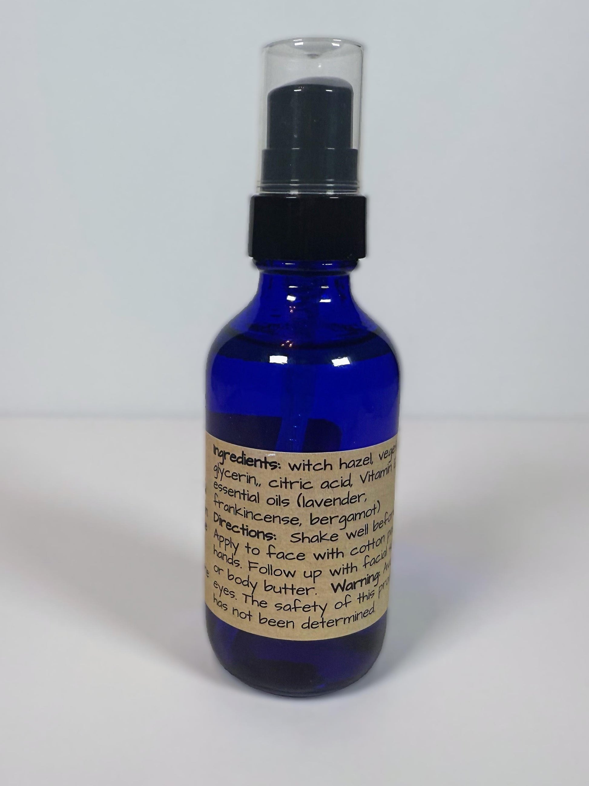 Blue spray bottle with a label on a white background