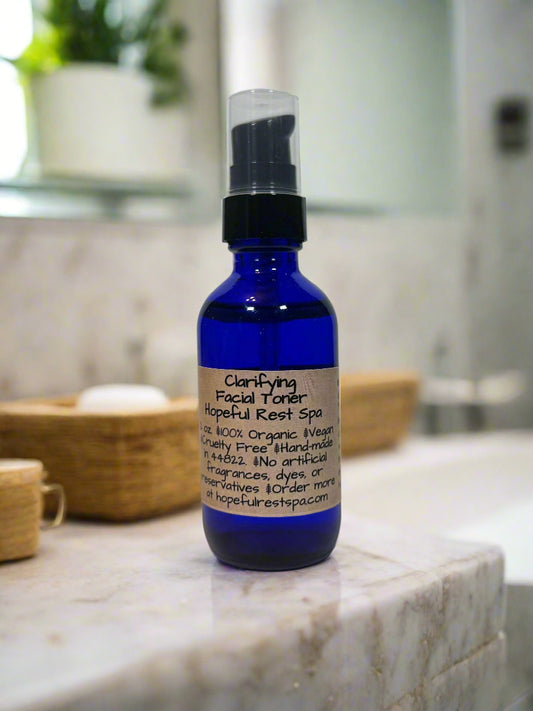 Blue bottle of facial toner on a bathroom counter with a blurred background