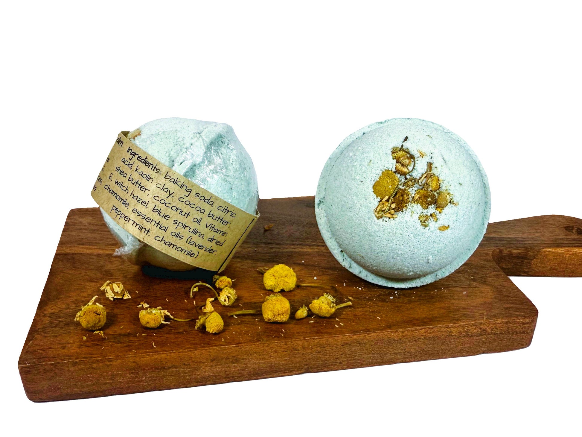 Two bath bombs on a wooden board with dried flowers, on a white background